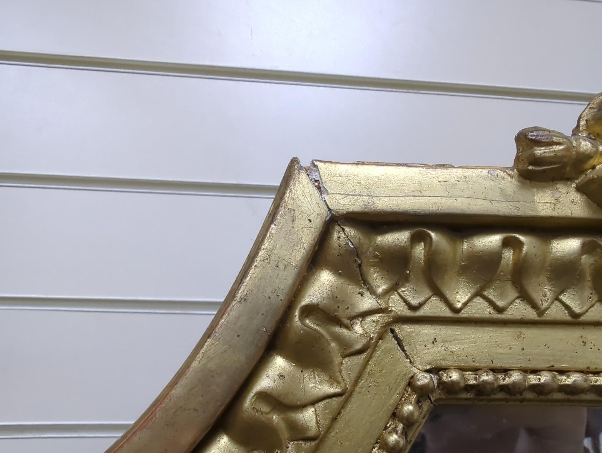 A late 19th century French Louis XVI style giltwood and composition overmantel mirror with floral swag pediment width 110cm, height 185cm.